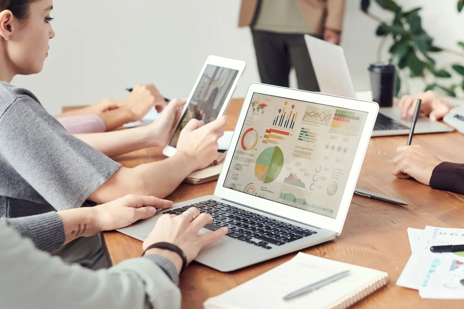 A laptop with digital marketing and advertising icons above the keyboard